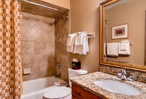Bathtub, towels, soap, shampoo