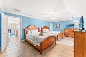 A bedroom with two wooden beds, a ceiling fan, a dresser, and a television. - Landshark, Luxury Oceanfront Cherry Grove Home with Game Room and Pool (North Myrtle Beach)