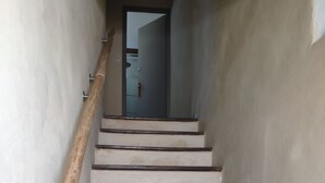 A staircase with wooden handrails and white steps leading to a door. - house for 4 to 6 persons fenced garden (Sainte-Jalle)