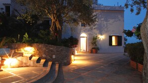 A building with a stone staircase leading to a door, surrounded by potted plants and a stone wall. - Borgo antico 1, Romantic Amalfi Villa Amalfi With Stunning Sea View, gardens (Amalfi)