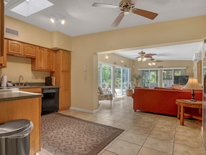 kitchen / living room with sliders out to pool and relaxing screen room