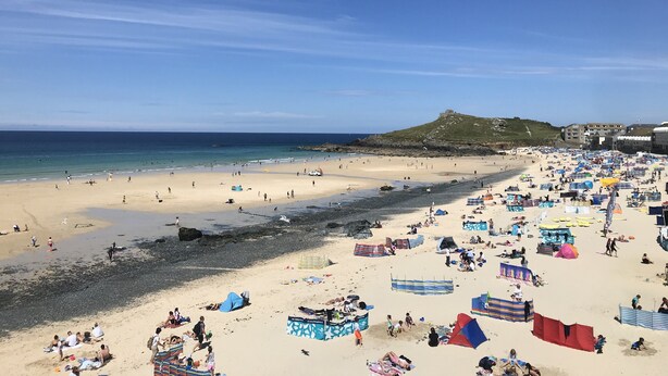 A beach with tents and people, a hill in the background, and clear skies. - Stunning 2 Bedroom Stone Barn with 24" Open Plan Living Room/Kitchen/Dining (Gulval)
