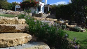 A stone staircase leading to a white building with a garden in front. - House in natural park with river, located 15' from Tarifa and beaches <br> (TARIFA)