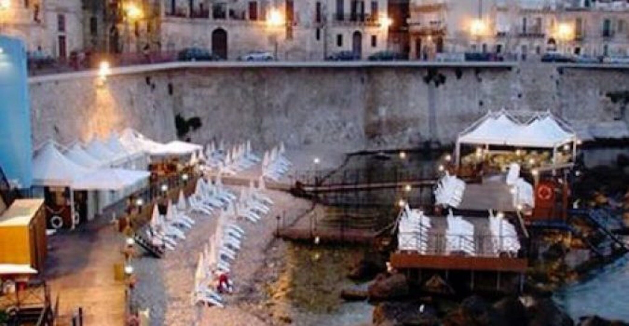 A courtyard with tents and tables, likely for an event or gathering.
