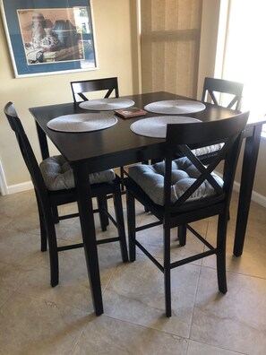 Enjoy meals in this cozy dining area with a table and four comfortable chairs.