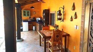 A kitchen with a dining area, a ceiling fan, and a wall-mounted lantern. - Casa de Como Casita #2 - Ajijic Village (Ajijic)