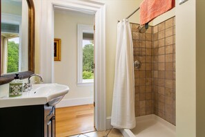 Bathtub, towels, soap, toilet paper