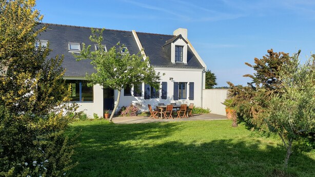 A house with a white exterior, a grey roof, and a small garden with a table and chairs. - 4* listed house with large private garden in a 6-hectare estate (Bangor)