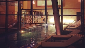 A pool area with lounge chairs and a wooden deck. - Luxury house in Sacred Valley. Modern comfort, rustic style, stunning views (Urquillos Urubamba)