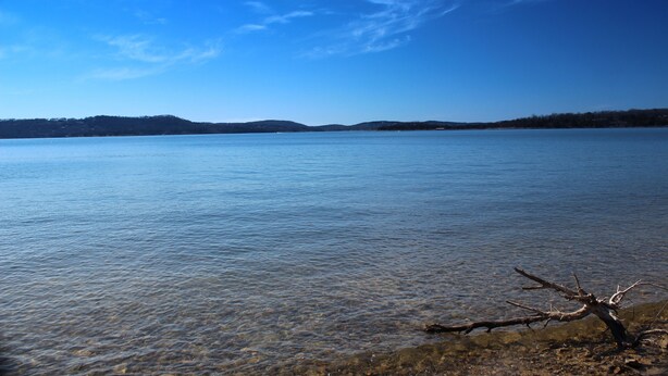 A calm lake with clear water, a visible shoreline, and distant hills. - Fabulous Patio View Overlooking The Main Channel Of Table Rock Lake (Hollister)