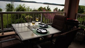 A dining table set for two with a view of a lake and hills in the background. - Fabulous Patio View Overlooking The Main Channel Of Table Rock Lake (Hollister)