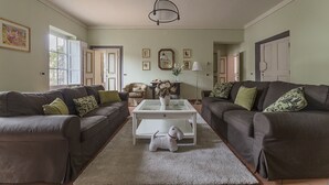 A living room with two dark sofas, a white coffee table, and a small dog toy. - Historical Center With Large Terrace (Lucca)
