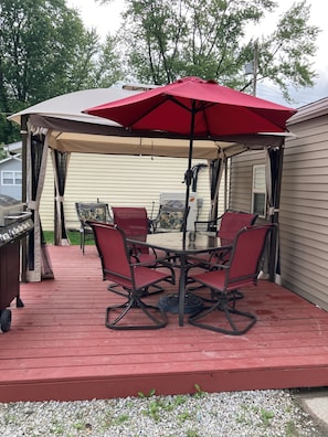 Relax under the shade of a covered patio, complete with a grill and comfortable seating for six.