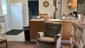 A compact living space with a kitchenette, a dining area, and a seating area.