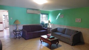A living room with two sofas, a coffee table, and a lamp.