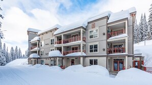 A multi-story hotel with balconies and a snow-covered exterior.