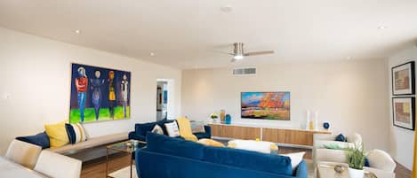 Spacious living room with vibrant art and lots of seating