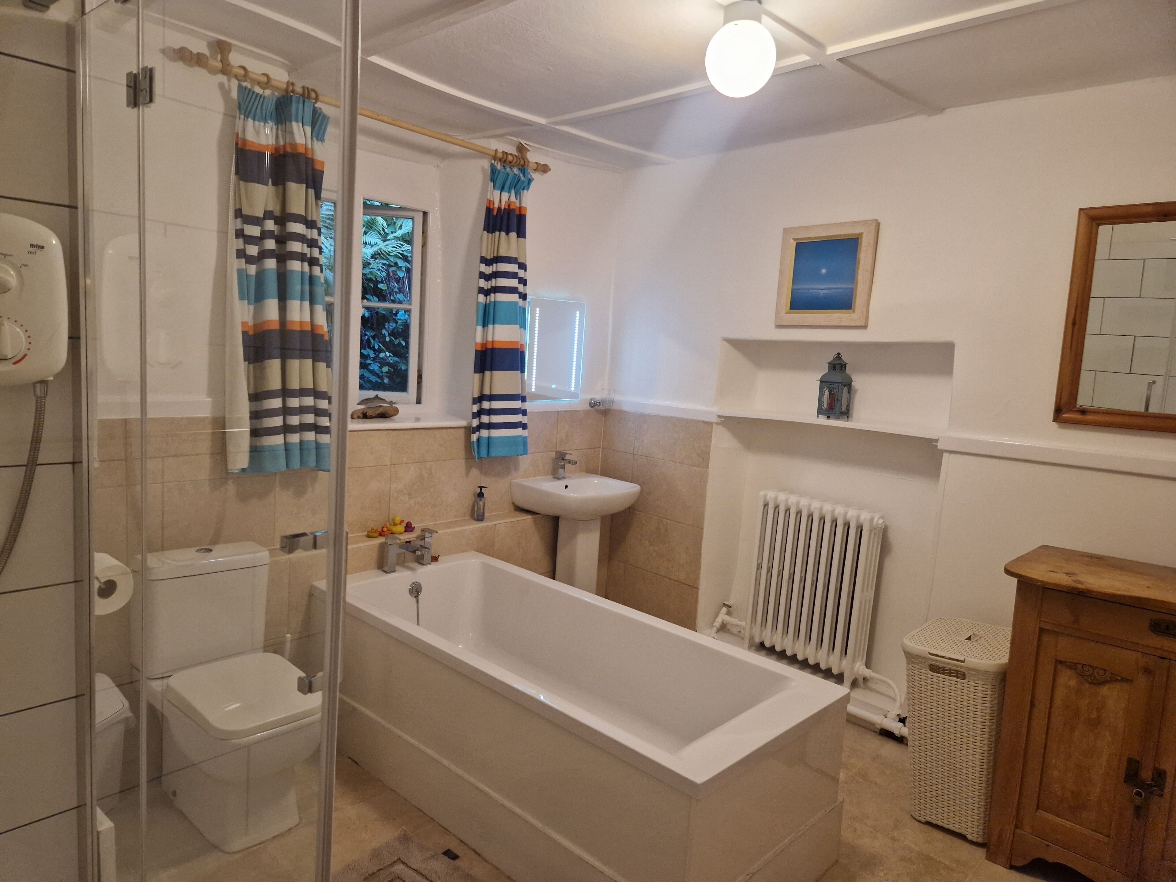 Large bathroom with separate electric shower.  Towels provided.