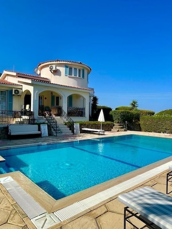 The pool area and back of the villa, looking towards the pool terrace