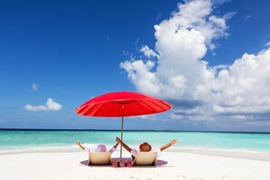 On the beach, sun loungers, beach towels