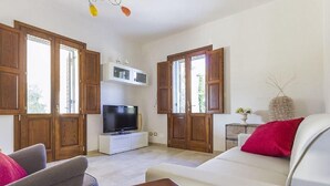 A living room with a TV, wooden cabinets, a sofa, and a dining table. - "VILLA ARGENTI" - VILLA WITH POOL BETWEEN SEA AND COUNTRYSIDE IN SALENTO (Melendugno (LECCE))
