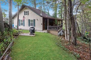 A two-story house with a porch and a covered front porch area.