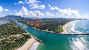 An aerial view of a coastal area with a beach, a river, and a town. - Beach Haven Villa - close to beach and breakwall (NORTH HAVEN)