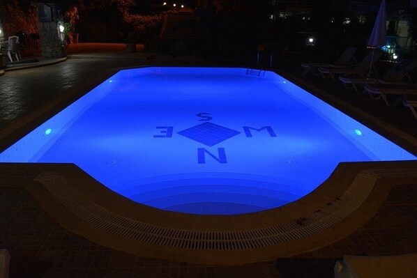 A swimming pool with a blue illuminated design and the letters "S M N E" visible on the water's surface. - Villa with large private pool, Bar and Gardens. Sleeps up to 14 adults . (Ölüdeniz)