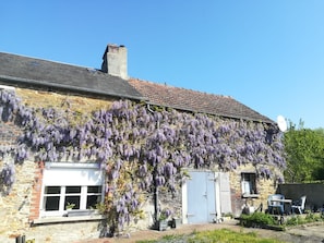 A stone building with a brick facade, a tiled roof, and a satellite dish. - Perfect hideaway in a rural setting, yet only a 10 minute walk to the village. (Cerisy-La-Forêt)