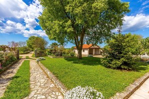 Stroll through the serene garden, surrounded by lush greenery and vibrant flowers.