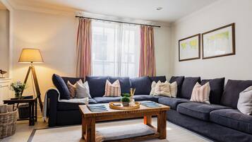 Relax in this inviting living space with a comfortable sofa, coffee table, and floor lamp.