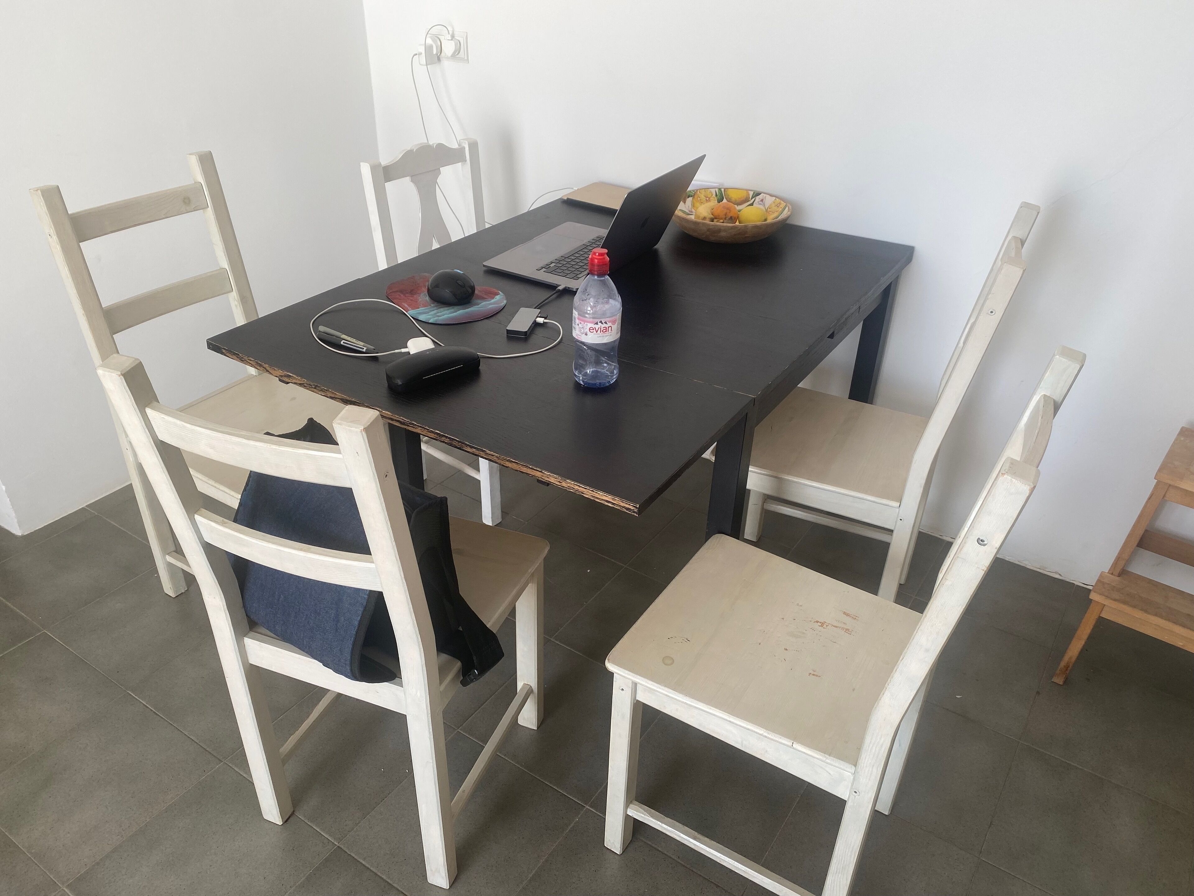 A small dining area with a table and four chairs.