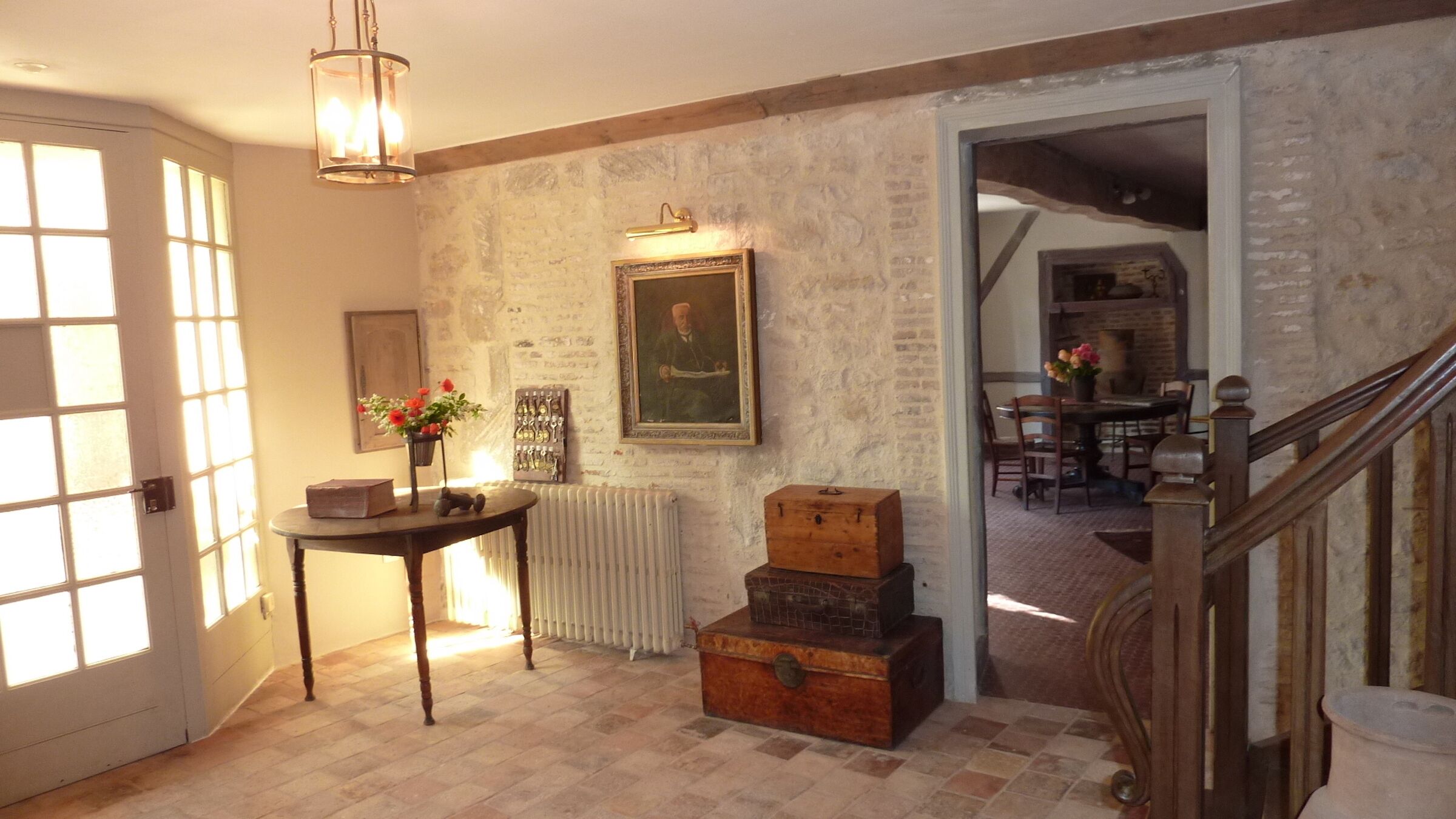 L'entrée à l'hôtel; le salon à l'arrière plan; l'escalier aux étages 1 et 2.