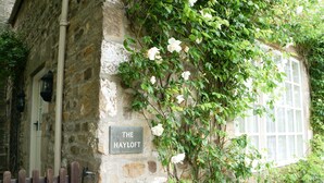 A stone building with a sign reading "THE HAYLOFT."