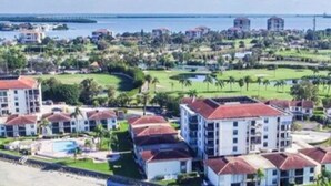 A resort with multiple buildings, a pool, and a golf course.