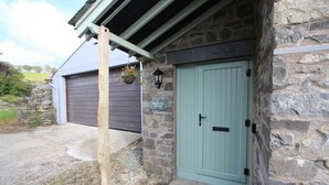 Un edificio de piedra con una puerta verde y un letrero que dice 'Orchard Noo'.