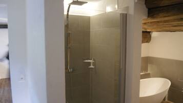 Bathtub, hair dryer, towels, toilet paper