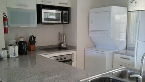 A compact kitchen with a microwave, toaster, and sink. - Apartment with Pool set In 70 Acres Of Beautifully Lush Tropical Gardens (Rockley)