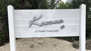 A wooden sign with the text "Kawana" and "A Private Community" indicating a private residential area.