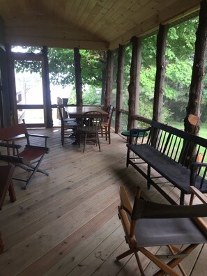 Screened Porch with dining table aand seating