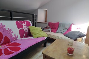 Cozy living space with a single sofa and a small table, perfect for relaxing.
