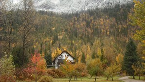 A house surrounded by autumn foliage and a forested mountain backdrop. - One Of A Kind Vacation Rental Located By The Base Of Boulder Mountain! (Columbia-Shuswap B)