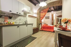 Fridge, stovetop, cookware/dishes/utensils, dining tables