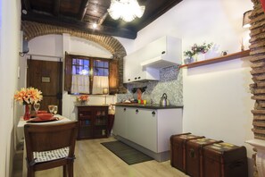 Fridge, stovetop, cookware/dishes/utensils, dining tables