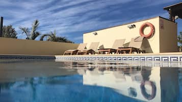 Una piscina al aire libre, una piscina climatizada