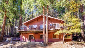 A cabin with a balcony, surrounded by tall trees. - (64) River Lodge at The Redwoods In Yosemite (Yosemite National Park)