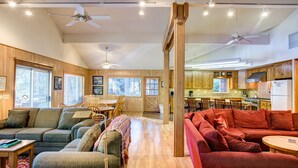 A spacious living room with a wooden ceiling, a dining area, and a kitchen. - (64) River Lodge at The Redwoods In Yosemite (Yosemite National Park)