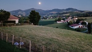 A rural landscape with a clear sky, a visible moon, and rolling hills in the distance. - Studio beautiful view of the Pyrenees  (Souraïde)