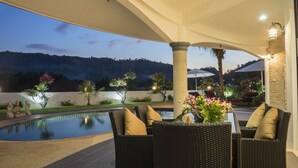 A poolside area with wicker furniture and a view of a mountain range. - Luxurious, quiet, private Pool-Villa Jasmine, 7/7 housekeeper/butler (Phuket)