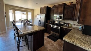 A modern kitchen with granite countertops, stainless steel appliances, and dark wooden cabinets. -  CORAL CANYON VIEW HOME !!!! UP ON THE LEDGE! DOG FRIENDLY! (Washington City)
